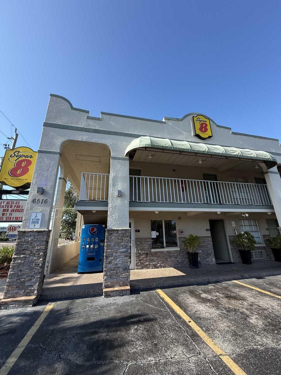 Super 8 by Wyndham hotel exterior before emergency roof tarping in Florida