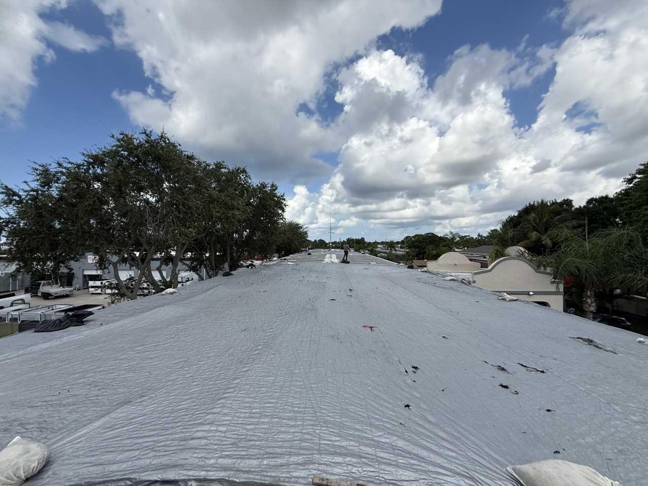Super 8 by Wyndham hotel roof fully secured with heavy-duty tarp after emergency roof tarping