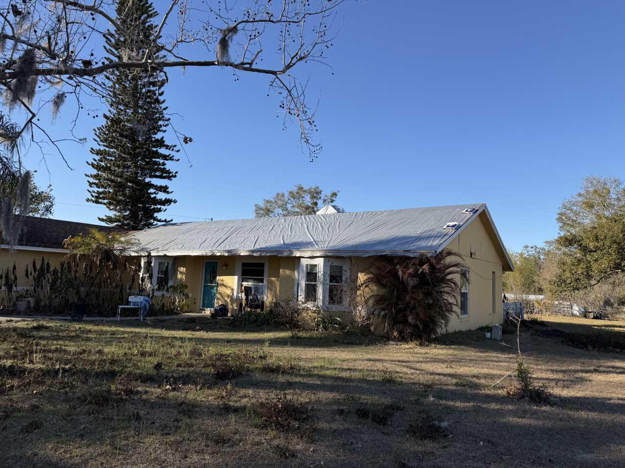 Completed emergency roof tarping job on a Florida home