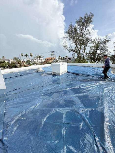 Roof fully secured with heavy-duty tarps after emergency storm response