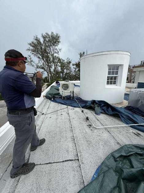 Exposed flat roof before emergency tarping on a coastal Florida property