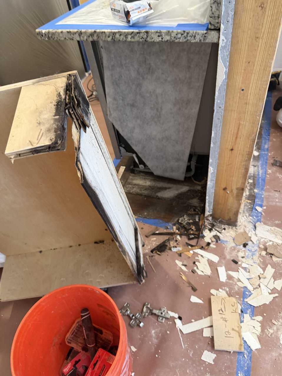 Commercial cabinet removed from the wall showing mold damage before remediation in Florida