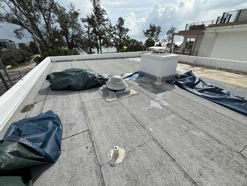 Flat commercial roof before tarps are deployed during emergency roof tarping