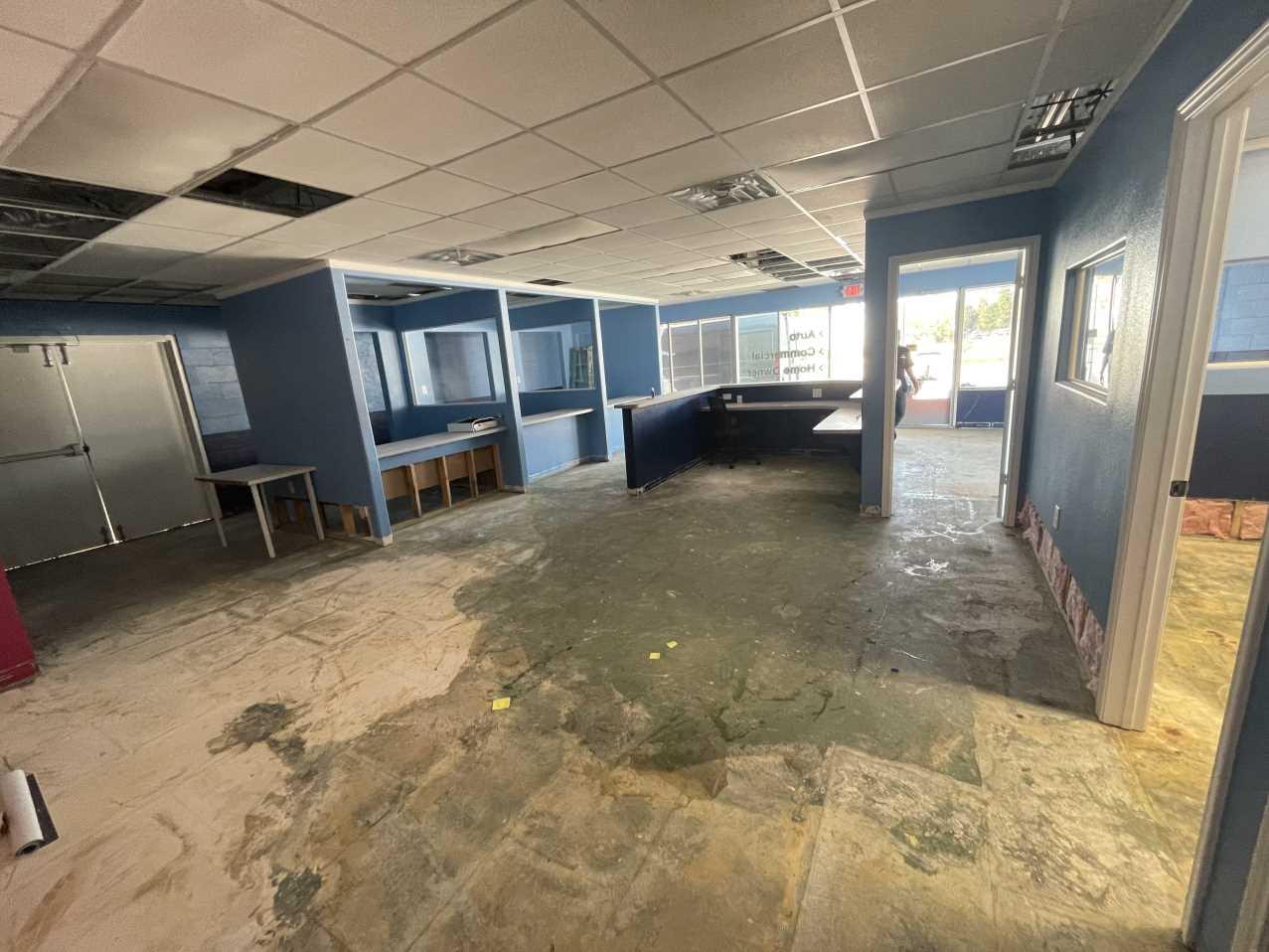 Commercial office space with ceiling opened up during storm damage restoration