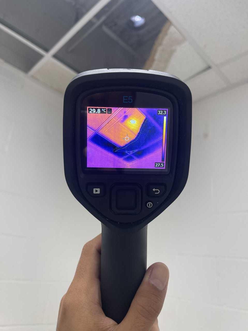 RFS technician using moisture detection equipment in a commercial office