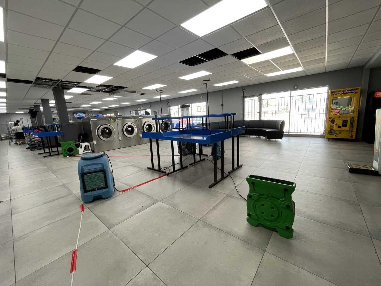 Commercial laundromat during final drying phase of water damage restoration