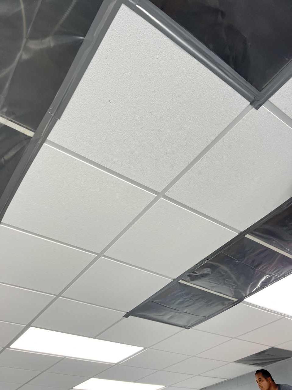 Close-up of ceiling tile containment during commercial water damage restoration