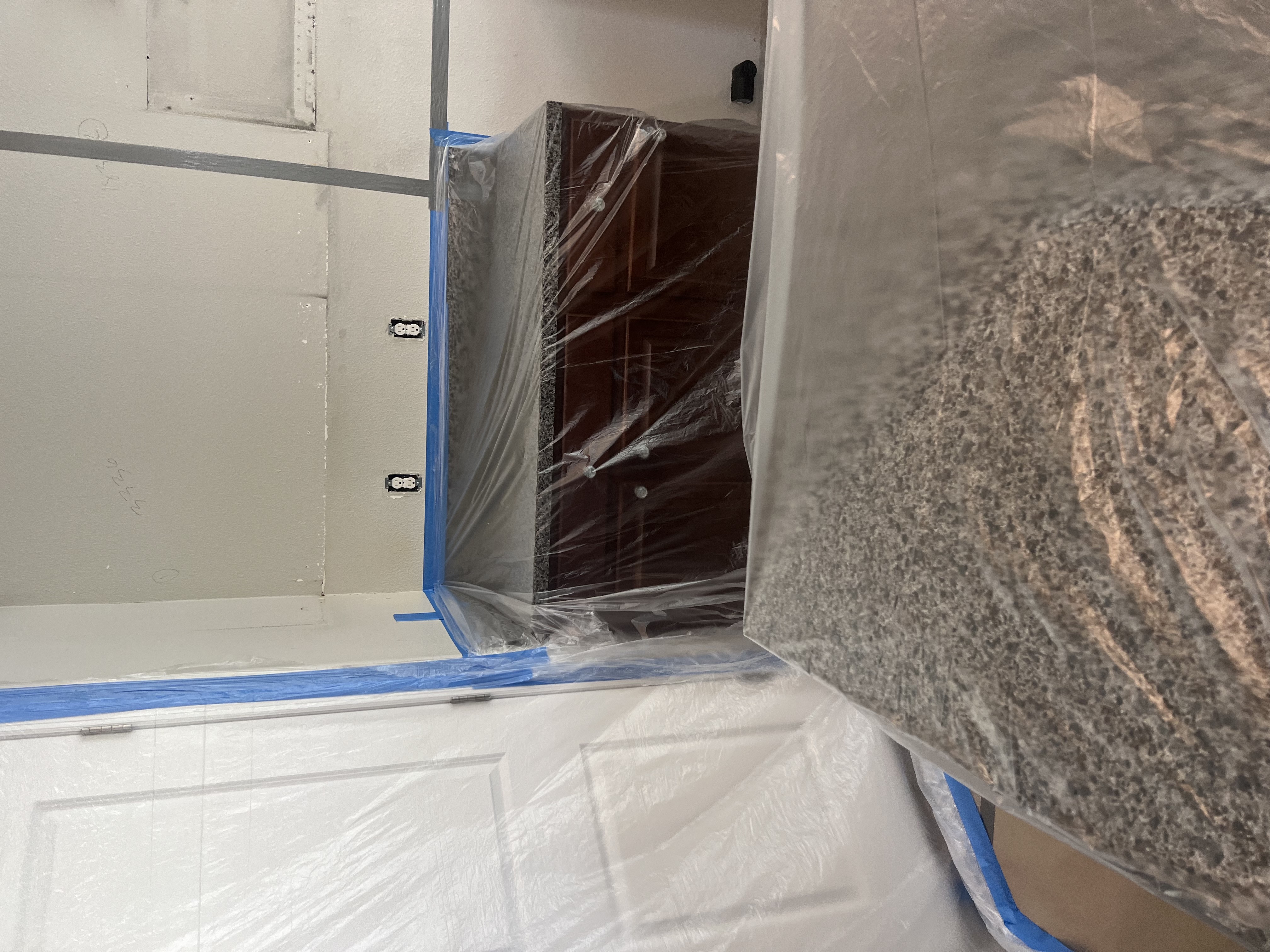 Plastic containment set up over kitchen cabinets during fire damage restoration