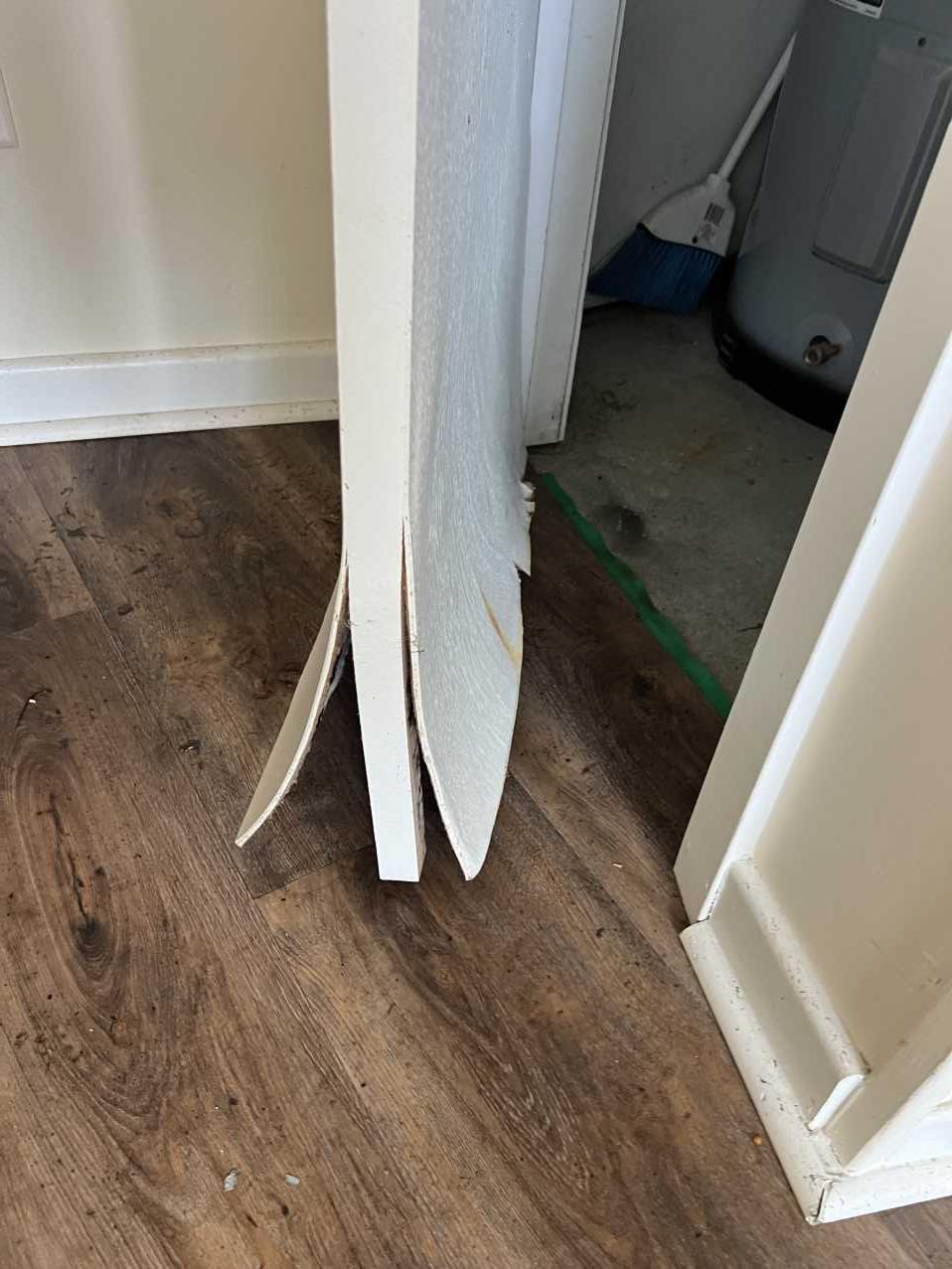 Close-up of water-damaged baseboard trim after hurricane flooding