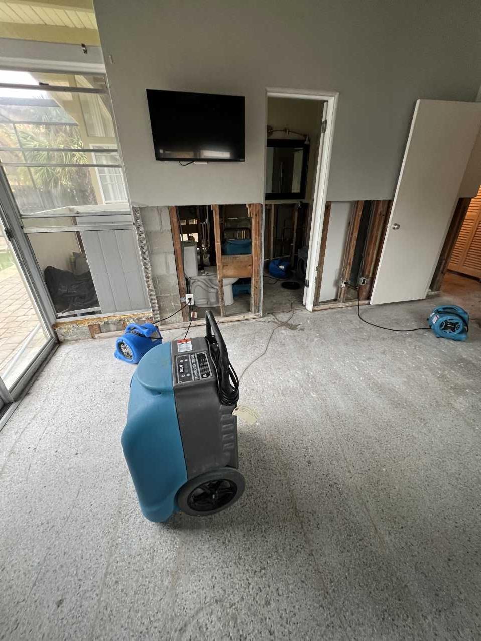 Drying equipment set up in a den after Hurricane Helene flood damage