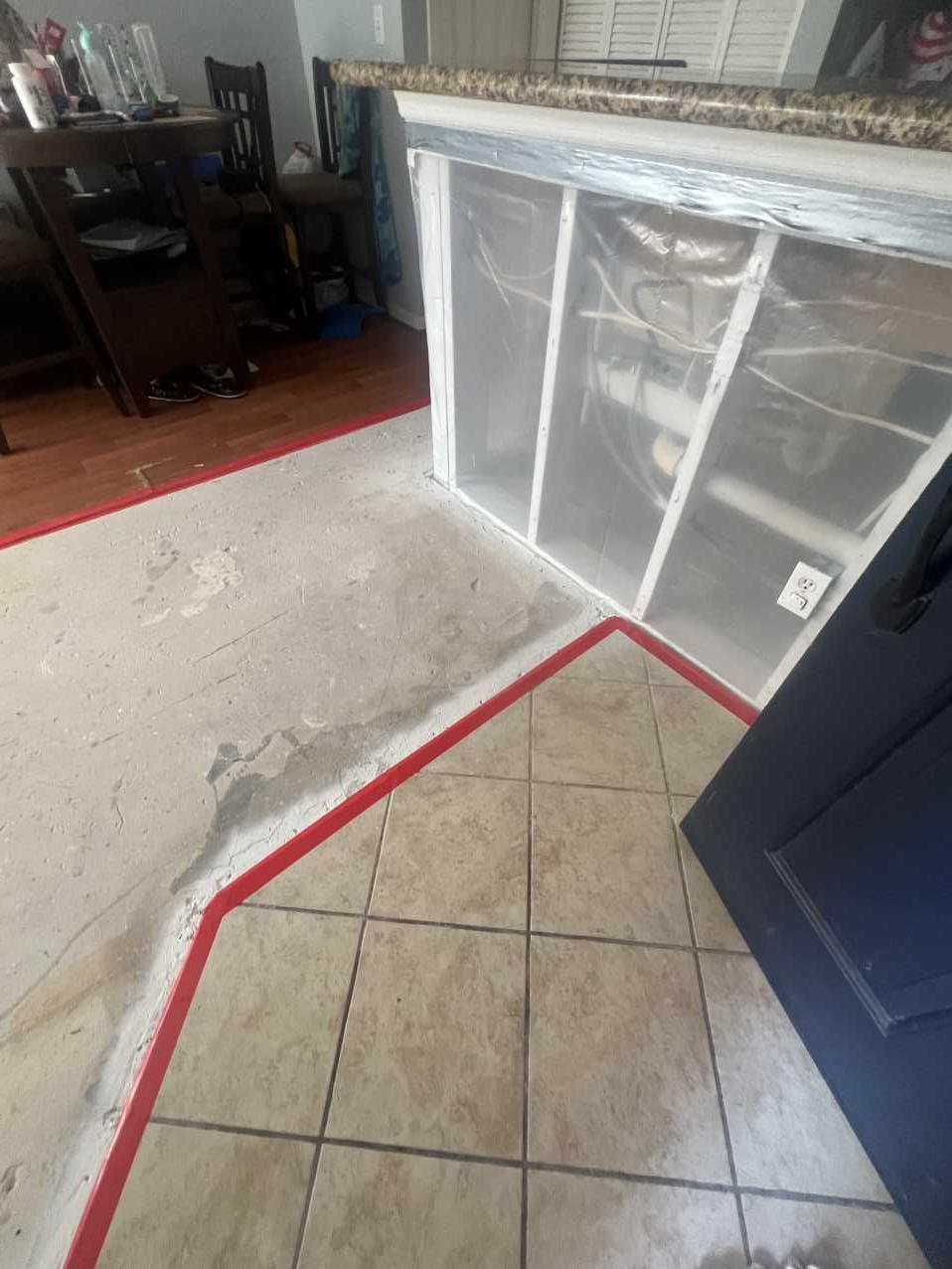 Containment boundary marked on a kitchen floor during final phase of mold remediation