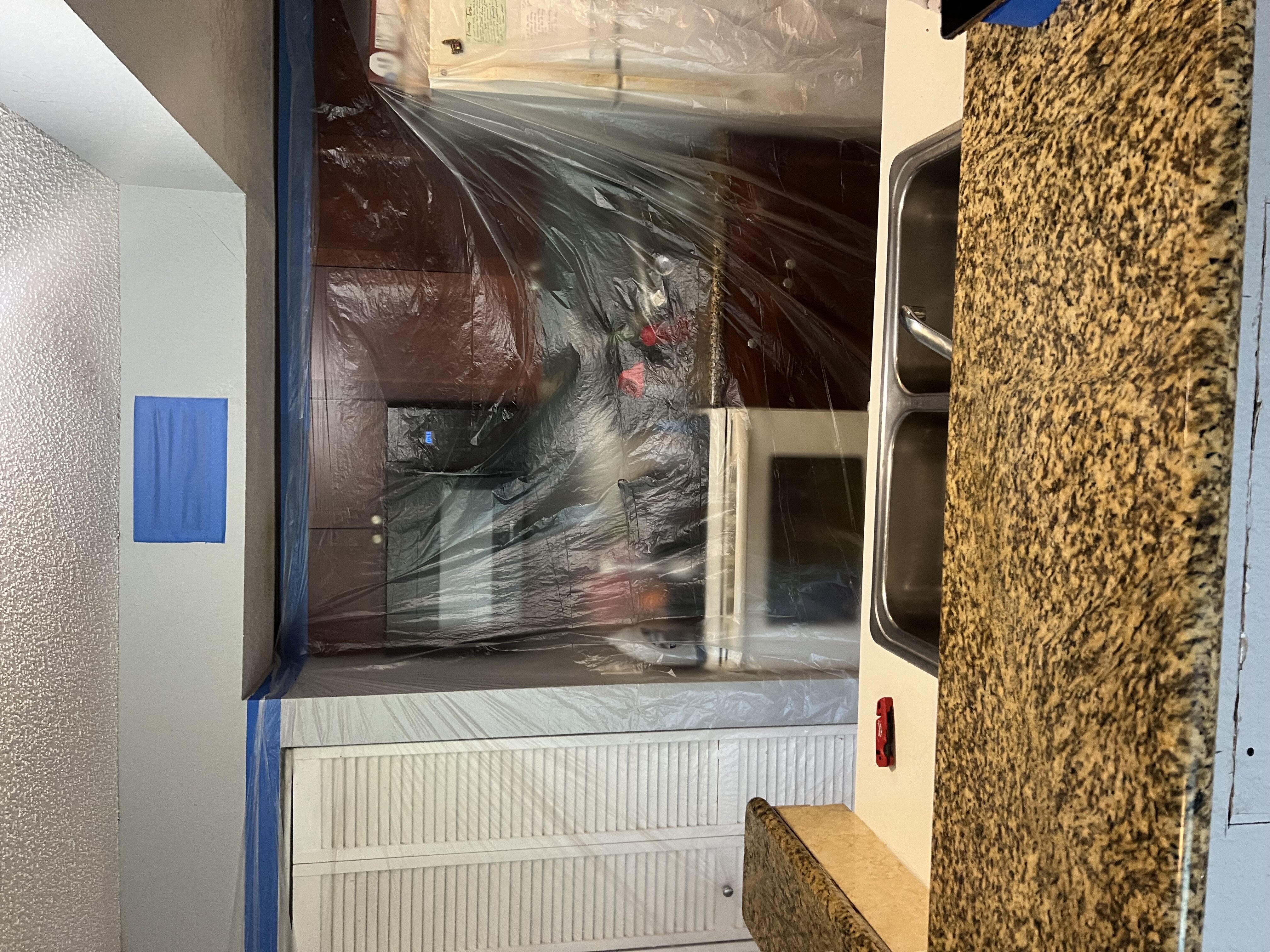 Plastic containment set up around a kitchen during mold remediation