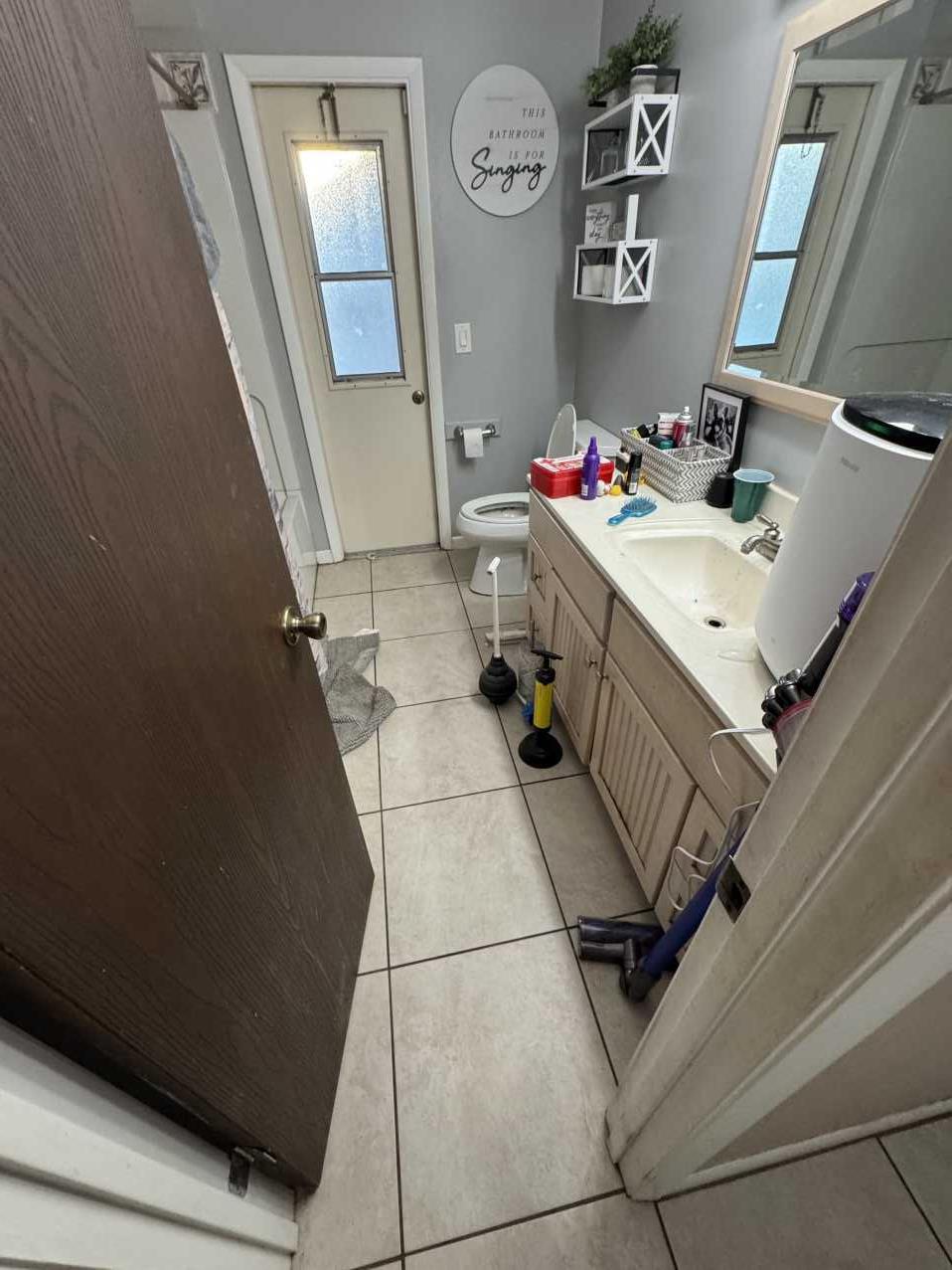 Bathroom before water damage restoration after a pipe burst in a Florida home