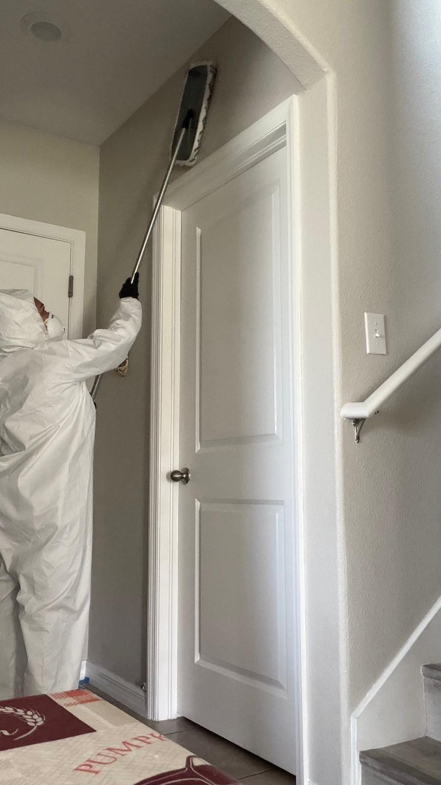 RFS technician detail-cleaning a ceiling corner
